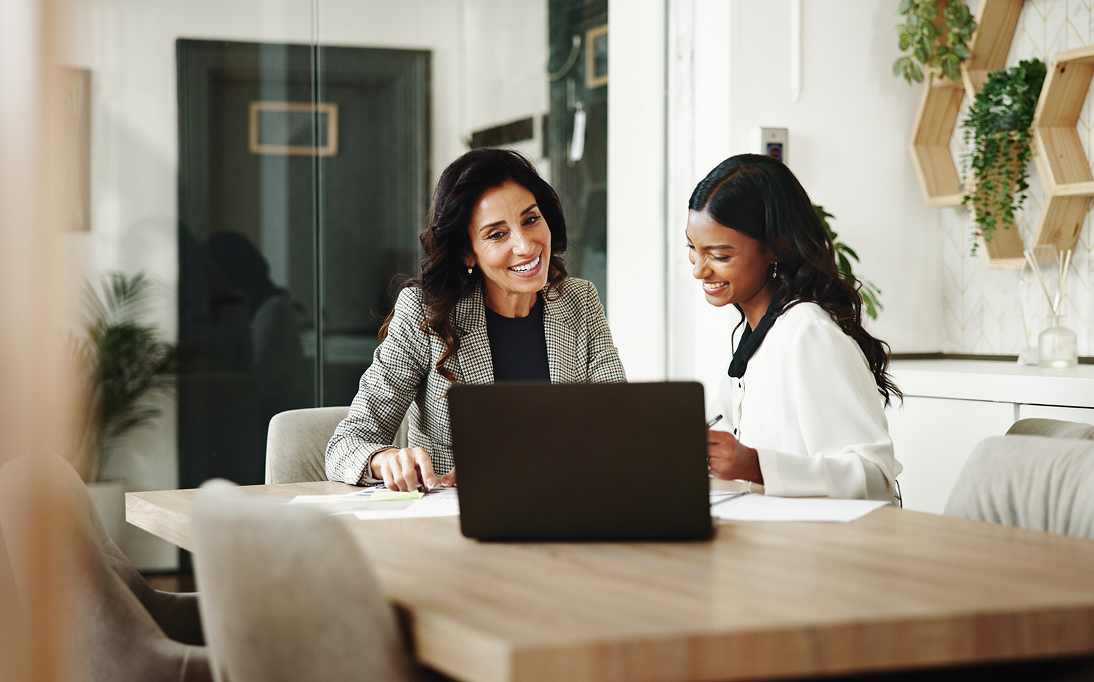 Two women discussing work at a table