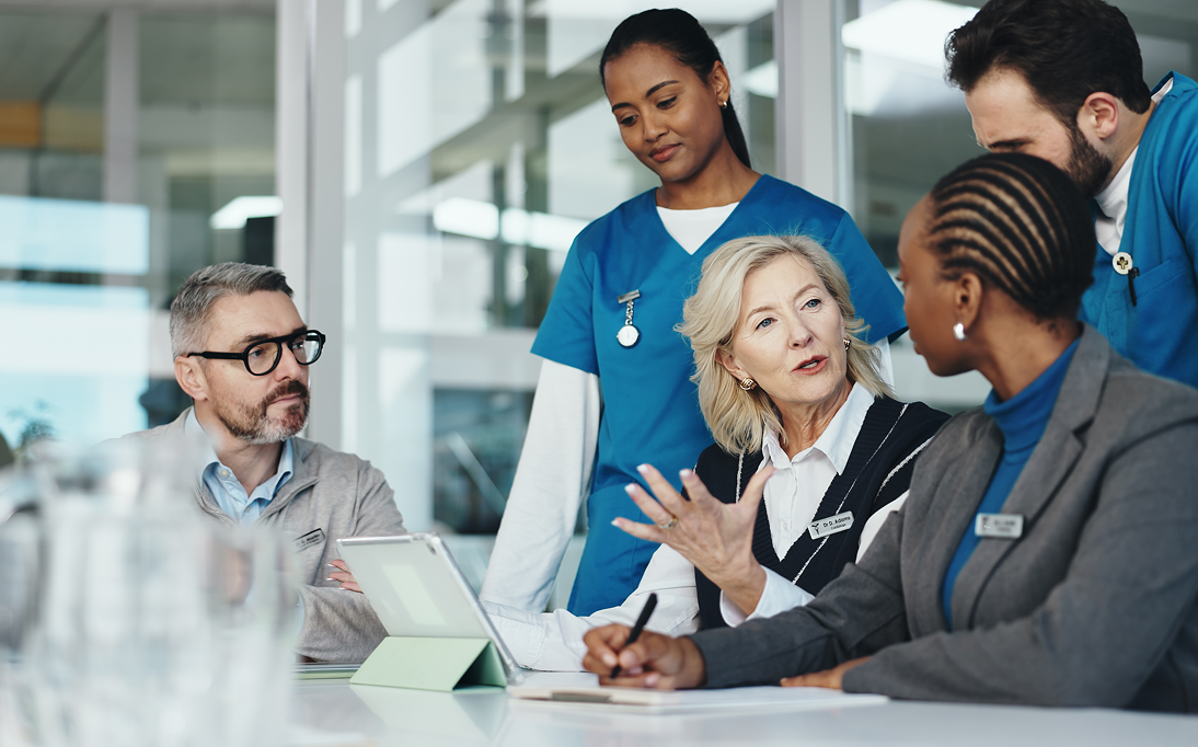Healthcare team in discussion at a table.