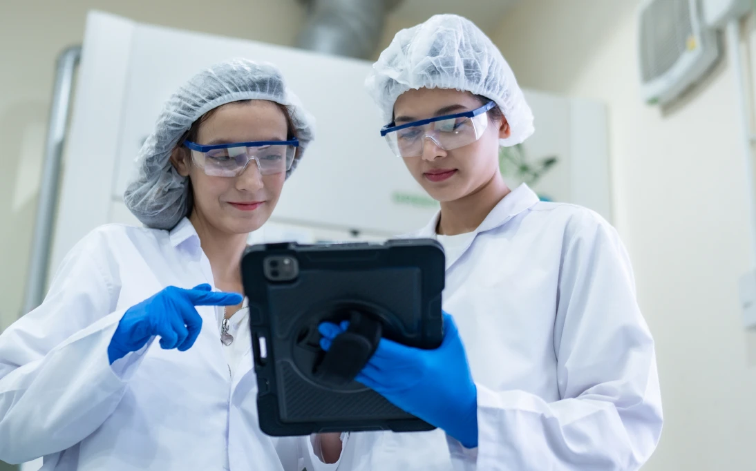 Laboratory team reviewing information on device