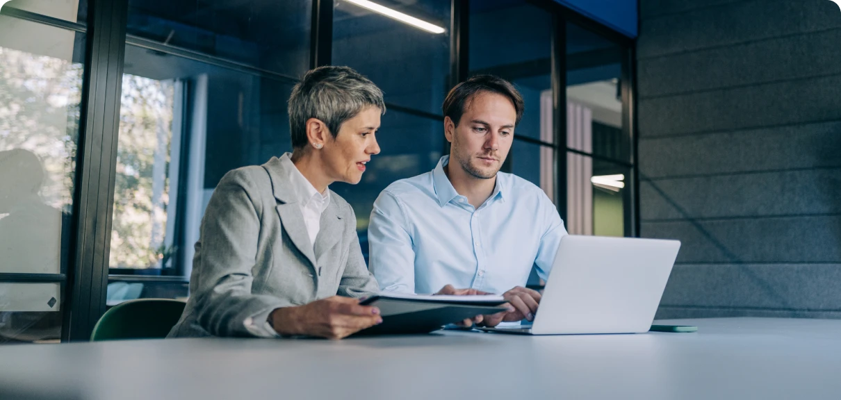 Professionals collaborating at work desk