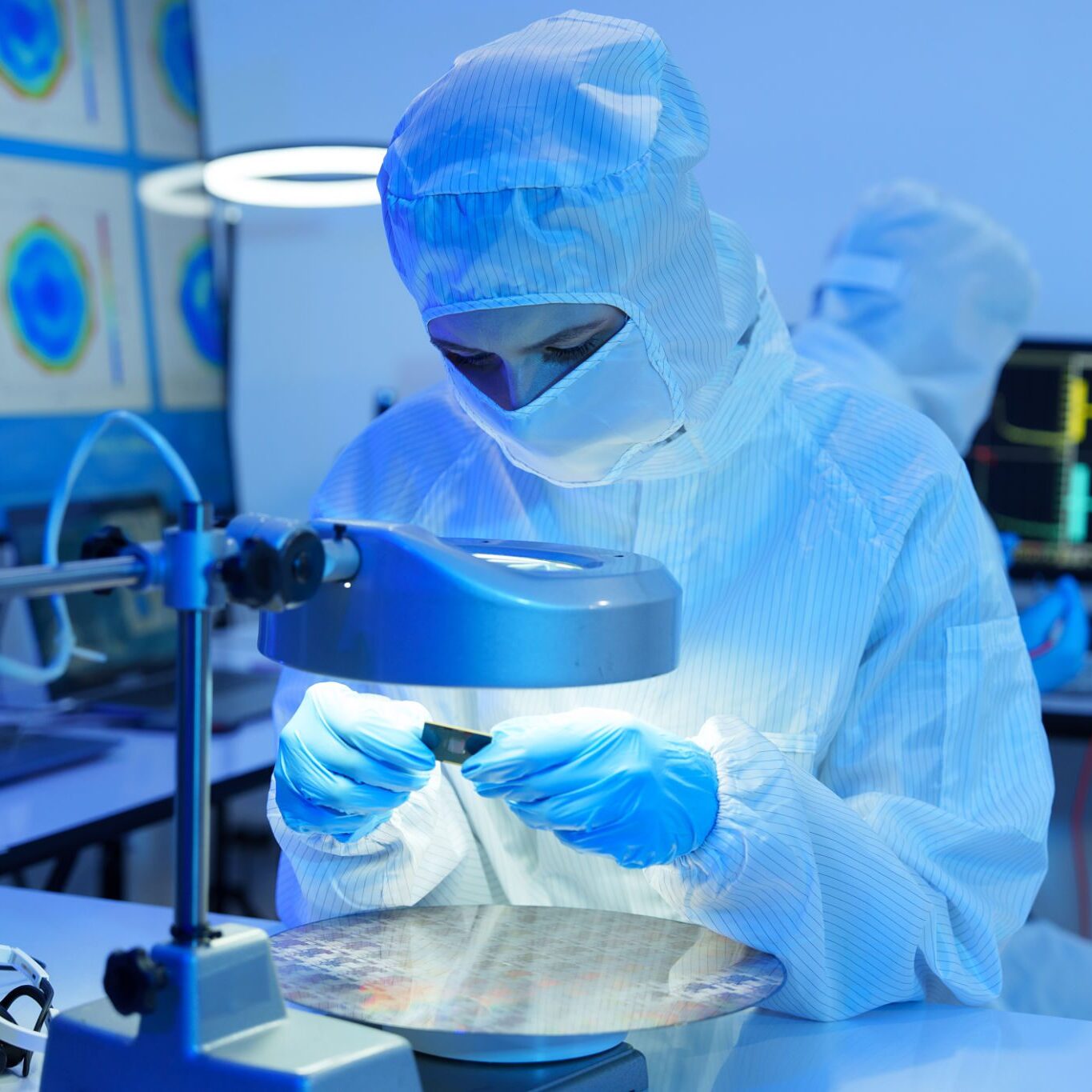 Technician analyzing under magnifying glass