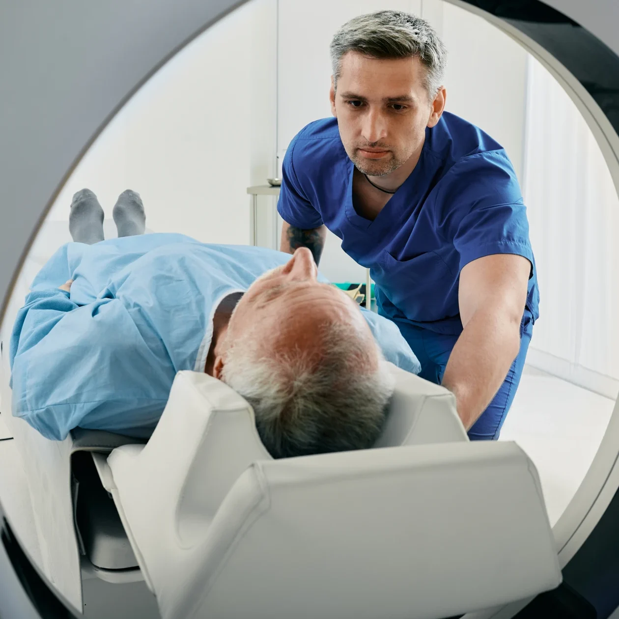 Man in blue scrubs with MRI patient
